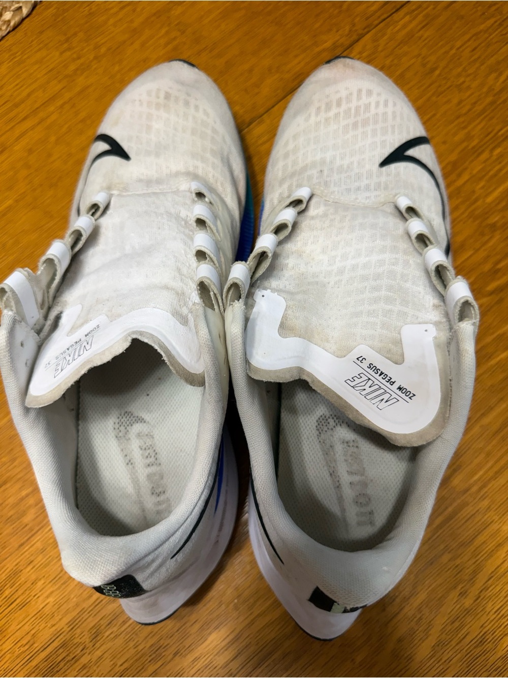 Nike Men’s White Athletic Shoes with Black Swoosh and Blue Accent